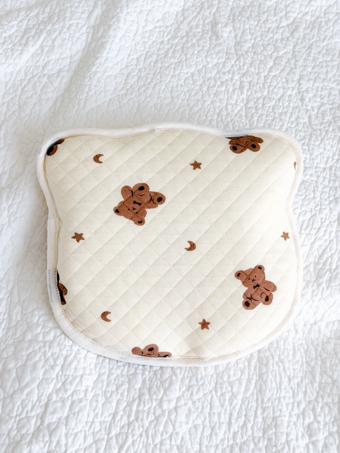 Quilted anti-flat-head baby pillow in cream with teddy bear, moon and stars print — gentle head shape support, included in Maxims Gift Co. Hello Little Cub gift box

