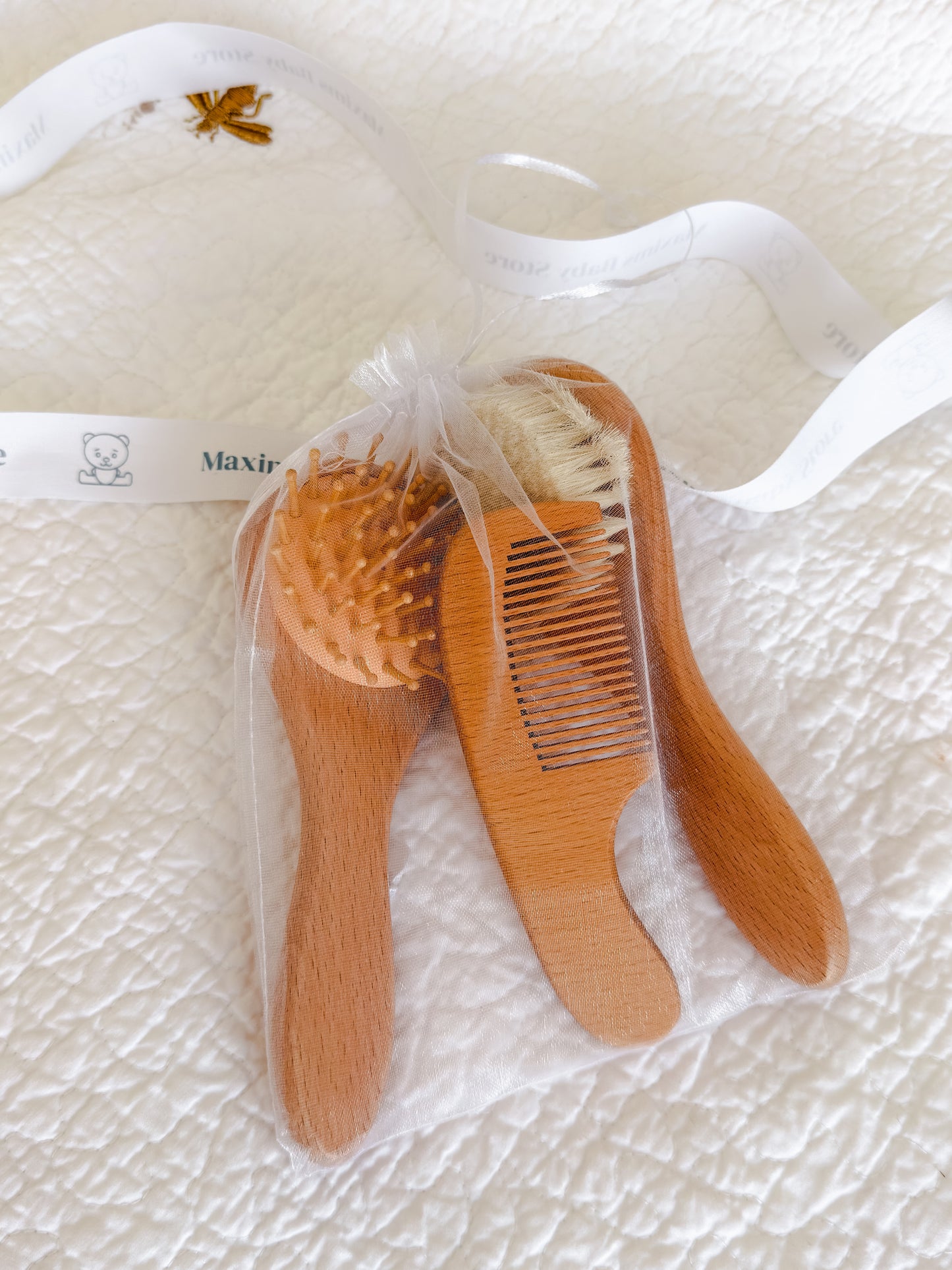 Wooden baby brush and comb set presented in organza gift pouch — perfect baby shower and Aqiqah gift in Dubai
