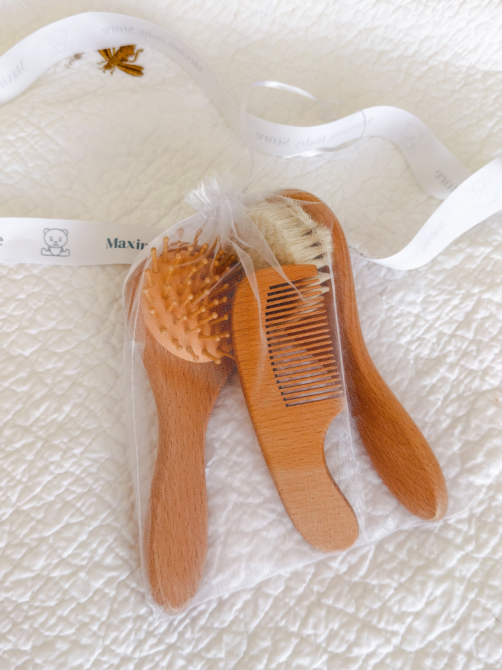 Wooden baby brush and comb set presented in organza gift pouch — perfect baby shower and Aqiqah gift in Dubai
