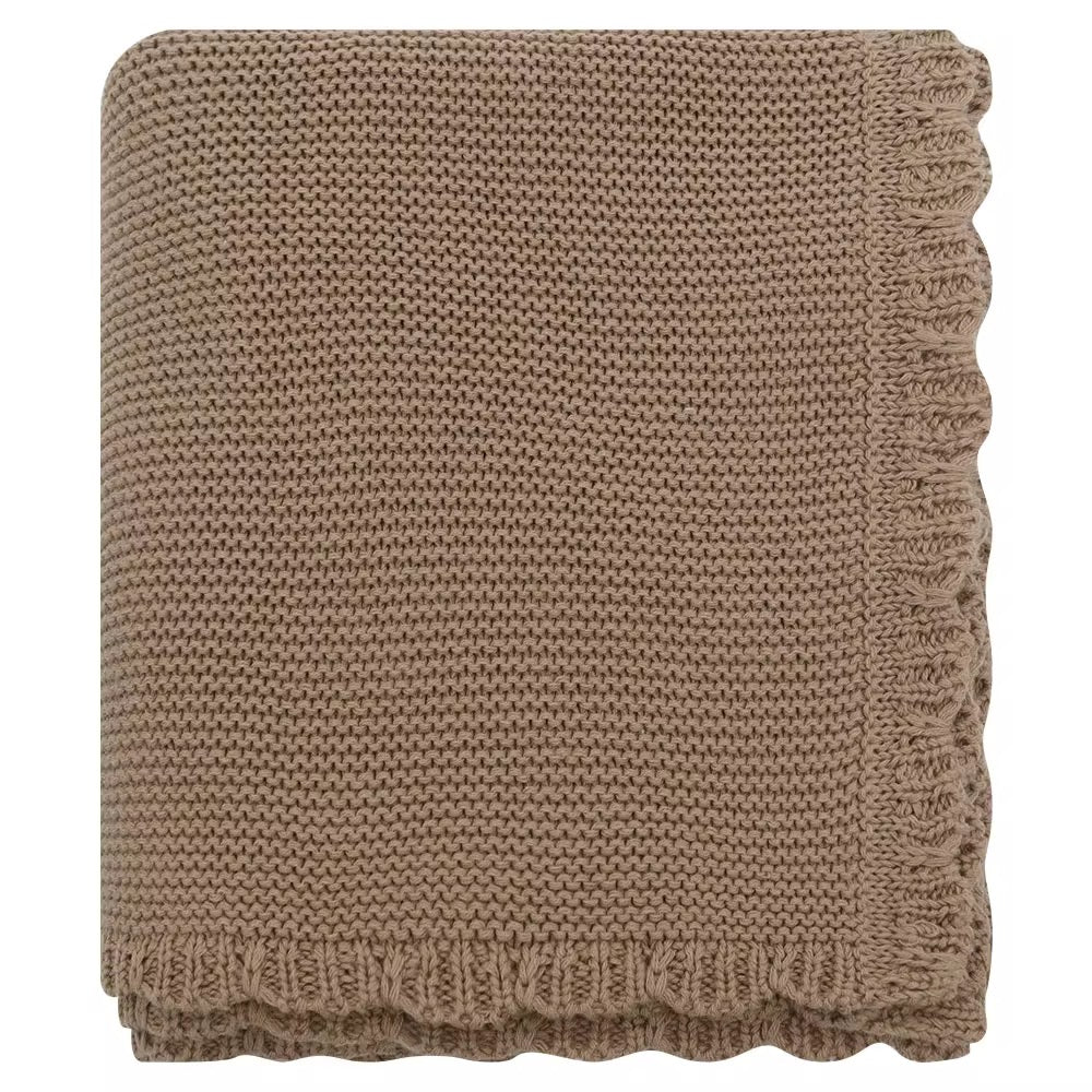 Brown scalloped knitted baby blanket folded on a white background with soft textured knit pattern.