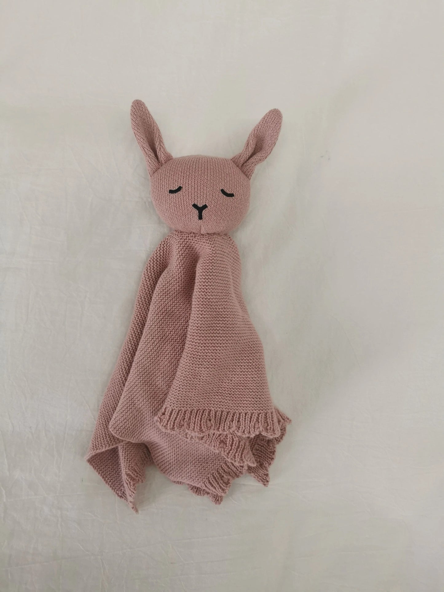Dusty rose scalloped knitted bunny comforter lovey blanket for babies and toddlers.