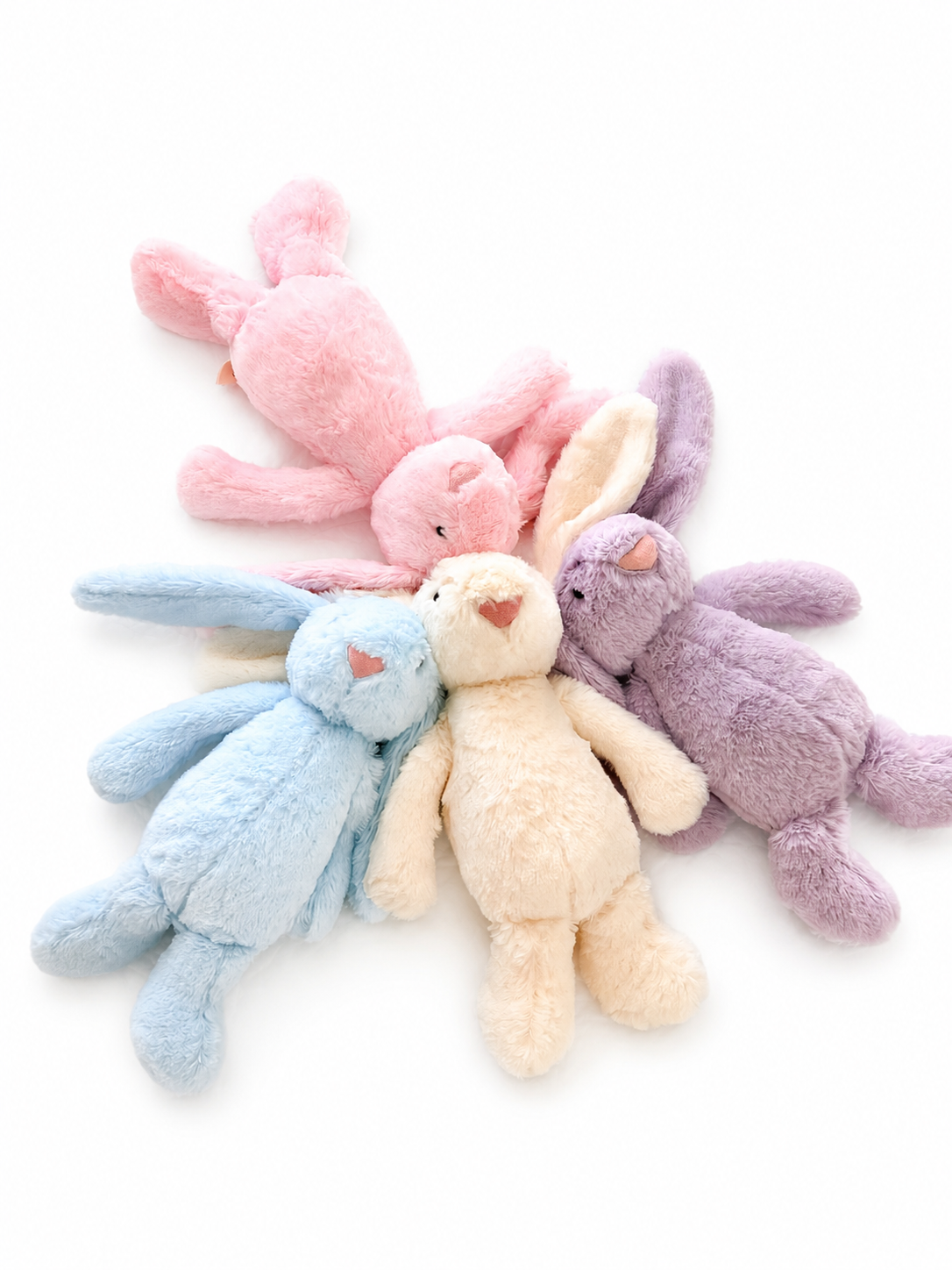 Four Maxims plush baby bunnies sitting in a row showing pink, blue, cream and purple colour options — UAE baby gift
