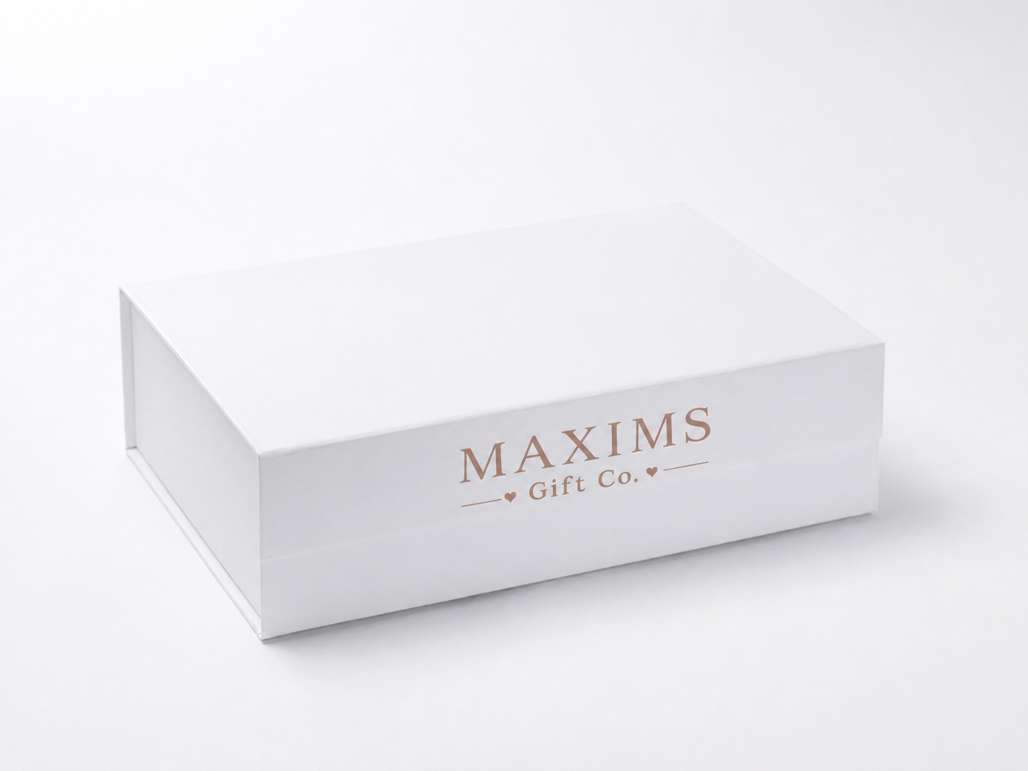 Premium Maxims Gift Co. signature white gift box with rose-gold branded logo — beautiful presentation for any baby gift order
