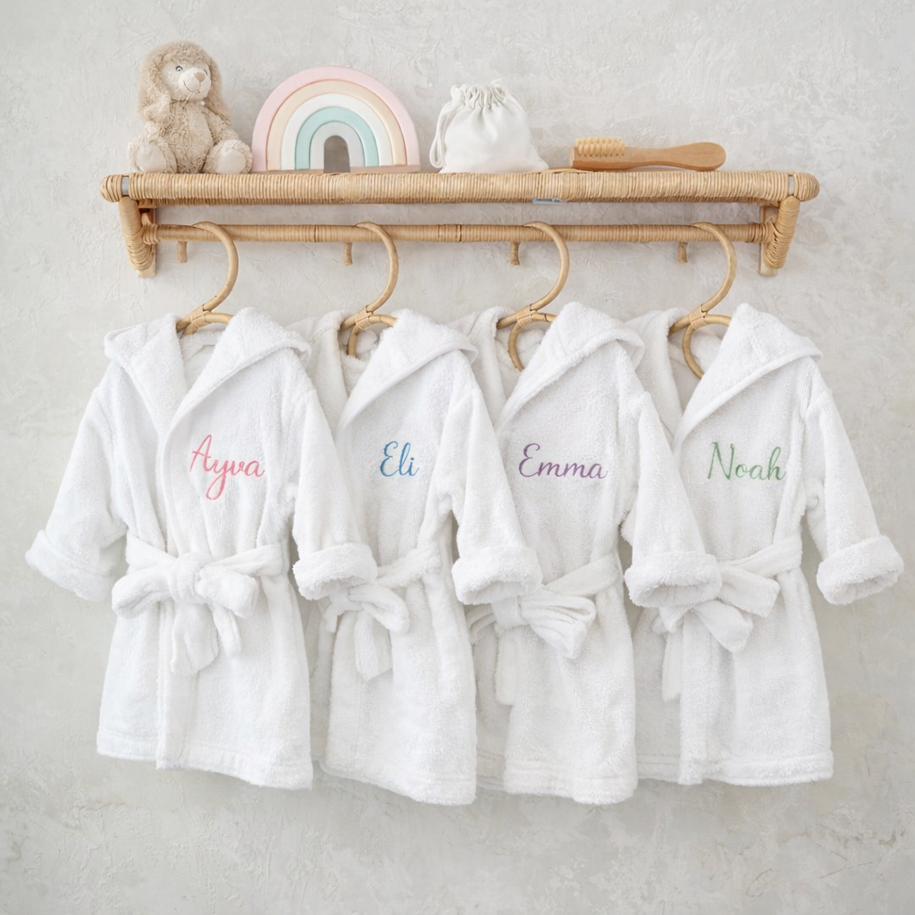 Personalised hooded baby bathrobes in organic cotton with embroidered names Ayva, Eli, Emma and Noah — Maxims Gift Co. Dubai UAE
