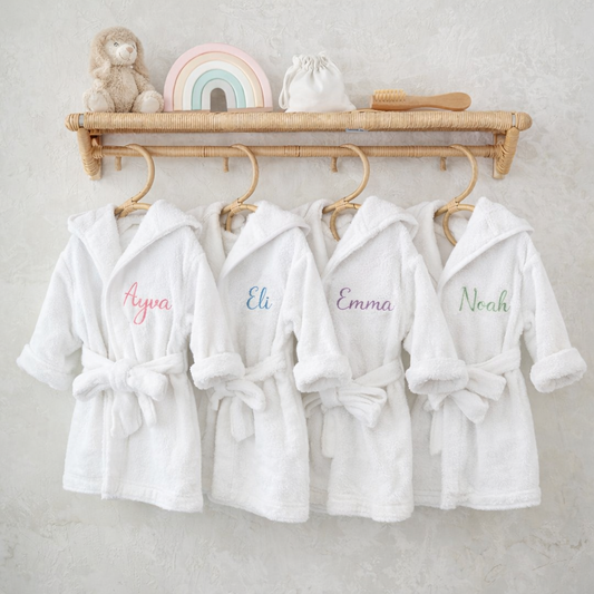 Personalised hooded baby bathrobes in organic cotton with embroidered names Ayva, Eli, Emma and Noah — Maxims Gift Co. Dubai UAE
