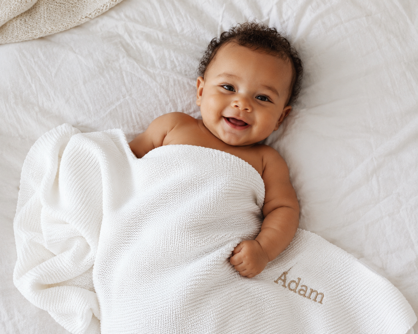 Close-up of Arabic name embroidery on white bamboo cotton baby blanket — beautiful keepsake gift for UAE families
