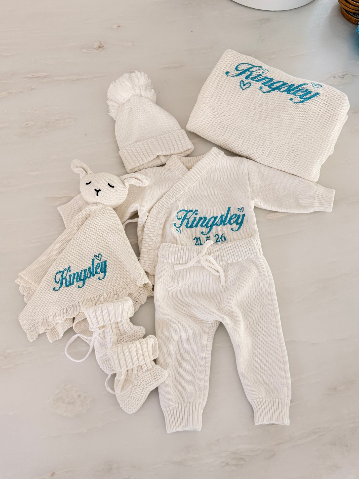 Personalised knit baby blanket and bunny comforter embroidered with baby’s name in blue thread