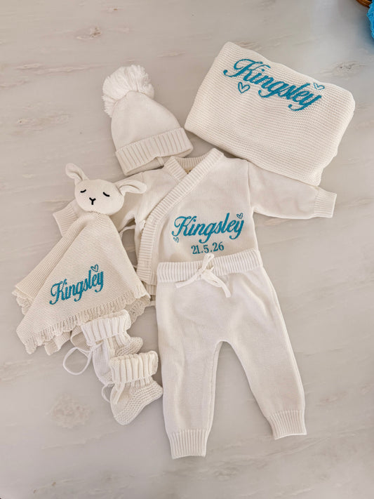 Personalised luxury newborn knit gift box with embroidered name Kingsley and birth date in blue