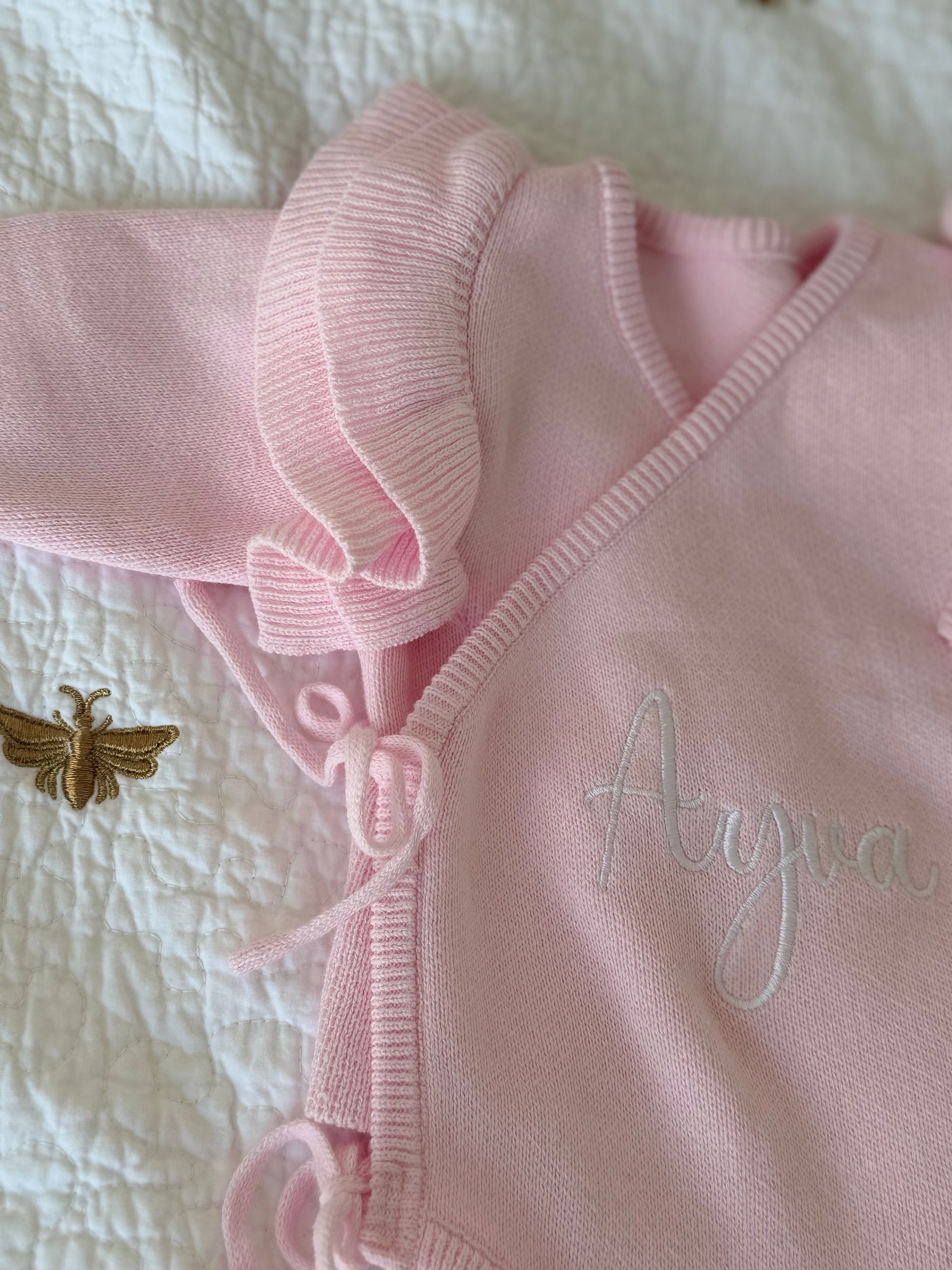 Close-up of embroidered name on pink organic cotton knit baby romper — Maxims Gift Co. personalised newborn gift UAE
