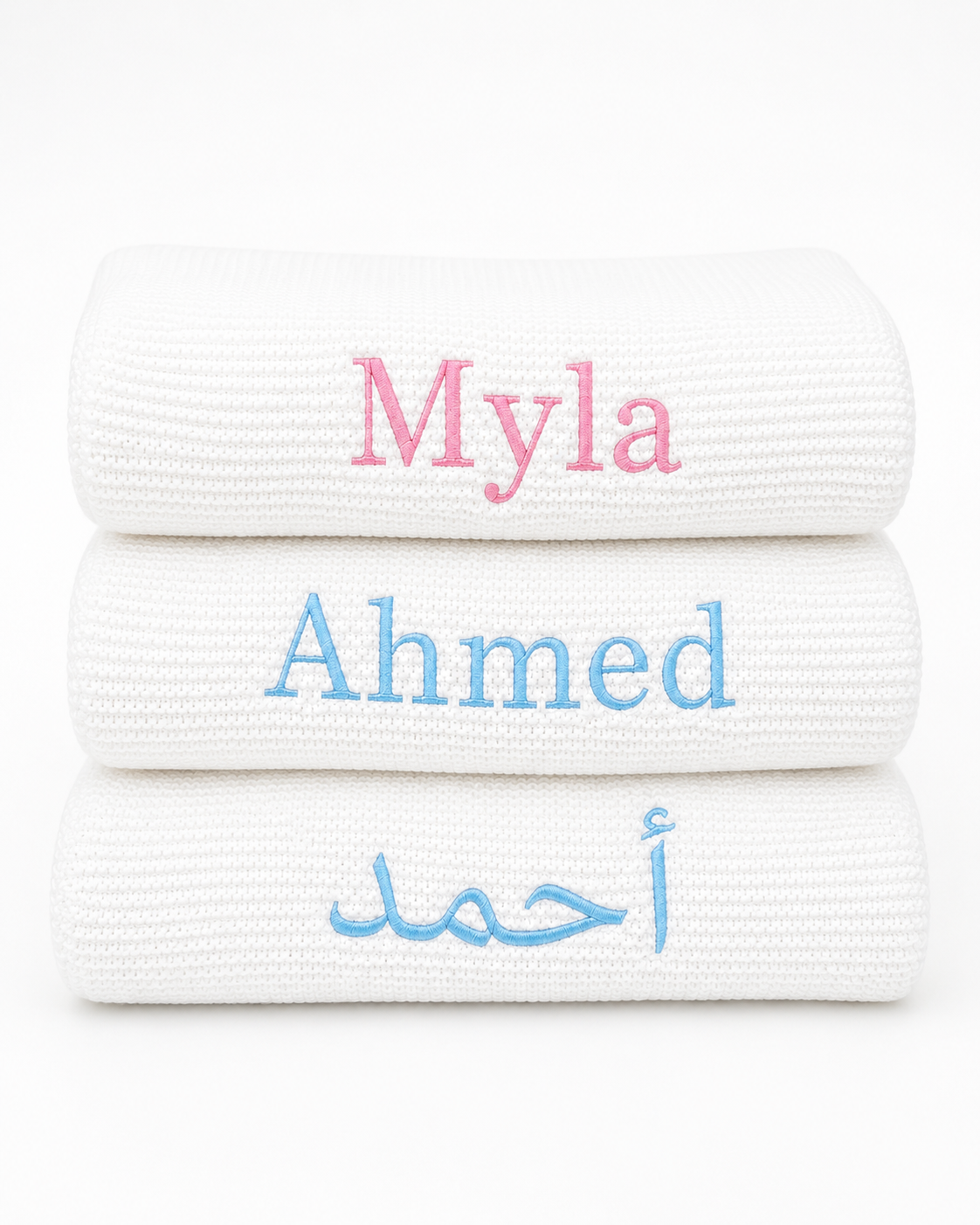 Folded personalised white baby blanket styled as luxury newborn gift — perfect baby shower and Aqiqah gift in Dubai UAE

